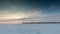 Timelapse. Russia. The movement of the clouds at sunset in the snowy steppe in winter.