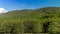 Timelapse of shadows and clouds moving on slopes of Radhost Hill overlooking a broadcast tower in a dense forest with moving shado