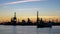 Timelapse: Silhouetted ship anchored off industrial plant and smokestacks