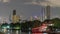 Timelapse skyscrapers in nightfall downtown and river at foreground