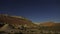 Timelapse stars and moon in canyon night sky.