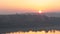 Timelapse Sun Rises Behind the Bell Tower of Church Among the Trees in Wide View