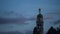 Timelapse at sunset blue hour of the bell tower with angel statue at Castle of Udine