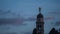 Timelapse at sunset blue hour of the bell tower with angel statue at Castle of Udine, zoom out