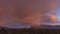 Timelapse sunset clouds mountains. A bright purple-pink sunset in the mountains.