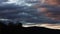 Timelapse of sunset clouds passing by and weather changing at dusk over the mountains, shot in Tasmania over Mount Wellington