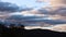 Timelapse of sunset clouds passing by and weather changing at dusk over the mountains, shot in Tasmania over Mount Wellington