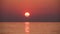 Timelapse of Sunset of the Great Red Sun in the sea. Orange sunny path with sea reflections.