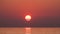 Timelapse of Sunset of the Great Red Sun in the sea. Orange sunny path with sea reflections.