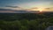 Timelapse of sunset over rolling hills of trees in Illinois