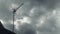 Timelapse of a television antenna against the background of fast-flying gray rain clouds