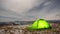 Timelapse, tent on a winter night on a mountain top with a view of the village in the carpathian mountains