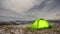 Timelapse, tent on a winter night on a mountain top with a view of the village in the carpathian mountains