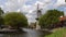 Timelapse. Traditional Holland Windmill on a channel in the Schiedam city near the Rotterdam, Netherlans