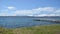 Timelapse video over deep blue ocean on a sunny summer sky with long rock pier going deep into the ocean