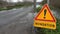 Timelapse Water over road, Road flooded by overflow of a river and danger road sign