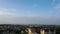 Timelapse white clouds passing over city