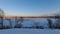 Timelapse winter landscape on a frozen lake on a sunny day with fishermen on ice