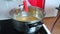 Timelapse woman preparing cream for cake in a pan on the stove in the kitchen