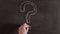 Timelapse write a question mark on a chalkboard. The question mark is drawn with chalk in hand close-up on the