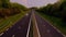 Timelapse - Zooming out on 4K Timelapse - Straight highway lane view with vehicles at dusk from day to night - a smoke, wind
