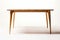 Timeless Minimalism: Scandinavian Dining Table with Light Wood Finish on White Background