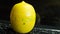 A timer in the form of a lemon. On a black laptop reversal