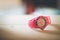 Times goes by, pink watch on a wood shelf