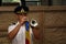 TIMISOARA, ROMANIA-08.20.2018 Young soldier in uniform with cap play the trumpet with national flag a specific song to commemorate