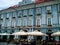 Timisoara / Romania - October 12, 2019: Cobblestone pavement in the old city. Cafe - a restaurant under umbrellas and the facade