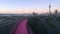 Timplapse of bright pink cycleway and Auckland skyline