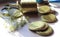 Tin lids for canning with a branch of dill on the background of the seaming machine, close-up