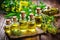 tinctures in dropper bottles with fresh medicinal plants on table