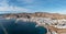 Tinos island Hora town Cyclades destination Greece. Aerial drone view of harbor breakwater sea sky