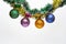 Tinsel with pinned christmas balls or ornaments, white background, copy space. Christmas ornaments concept. Balls with