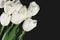 tinted image bouquet of a white tulips on a dark background. horizontal, space for text