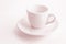 Tinted in pink white coffee cup and saucer, empty coffee-free coffee cup, front view from above, or black coffee, on a white