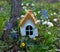 Tiny adorable fairy house under the tree in the garden