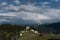 Tiny alpine village and ski lift in the Swiss Alps with a great view of a rainbow and mountain landscape