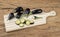 Tiny baby eggplants with slices over wooden board