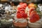 Tiny cakes on display with chocolate raspberry and strawberry and whipped cream toppings - Selective focus - Copy Space