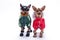 Tiny chihuahua and terrier toys in winter costumes.