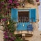 Tiny cozy vintage balcony with shutters decorated with illumination