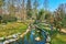 Tiny creek, lined with lush Camellia Park, Locarno, Switzerland