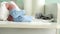 Tiny Cute Newborn Babies Feet In Blue Socks Early First Days Of Life On White Background. Close up of Small Legs of Baby