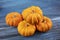 Tiny decorative orange pumpkins with textured background