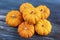 Tiny decorative orange pumpkins with textured background