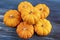 Tiny decorative orange pumpkins with textured background