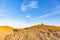 tiny figure of a child standing on huge boulders. Steppe landscape at sunset