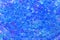 Tiny hard plastic beads balls in blue color background